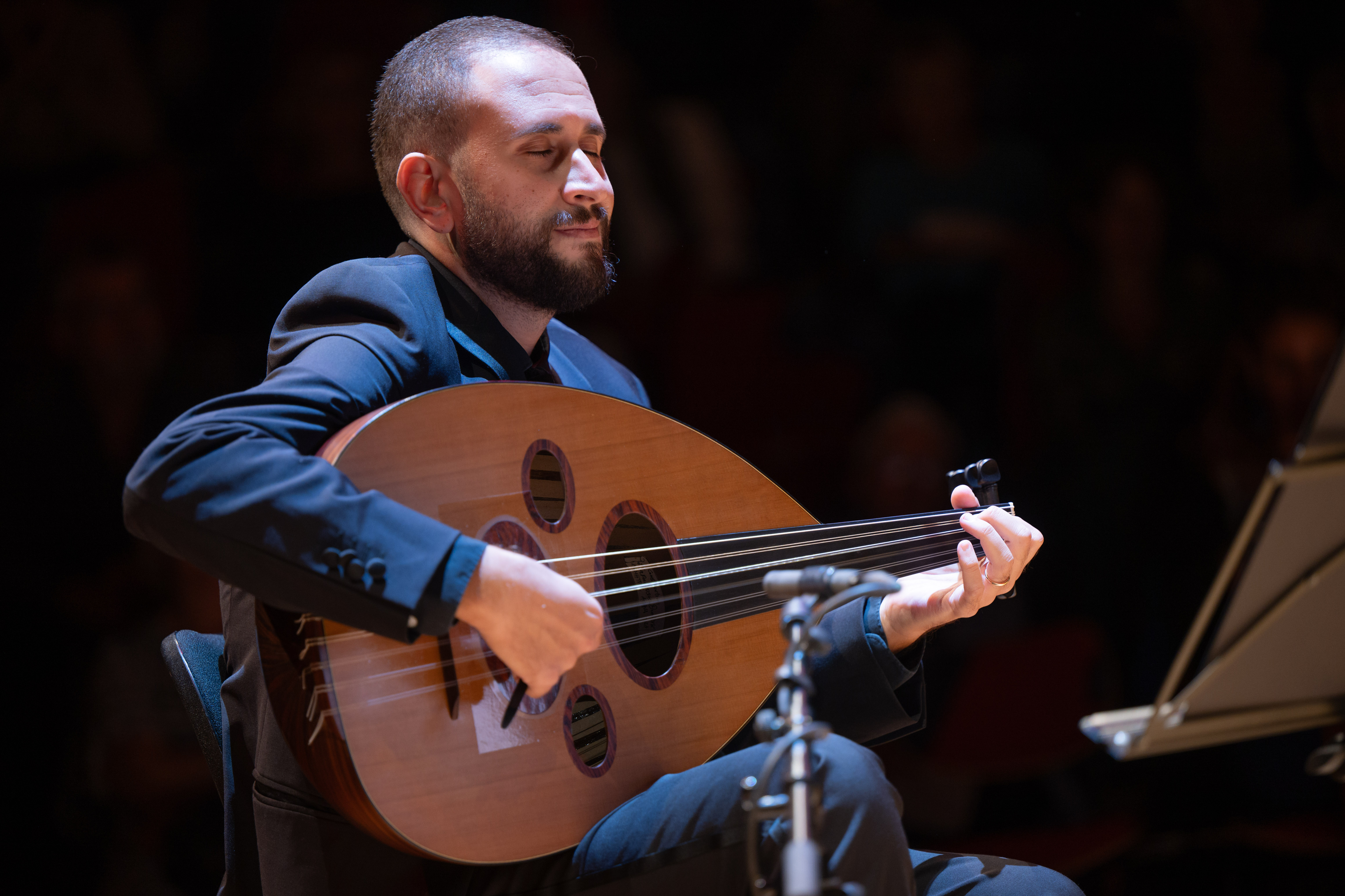 The musician, Michael Onsy, playing on his Oud instrument